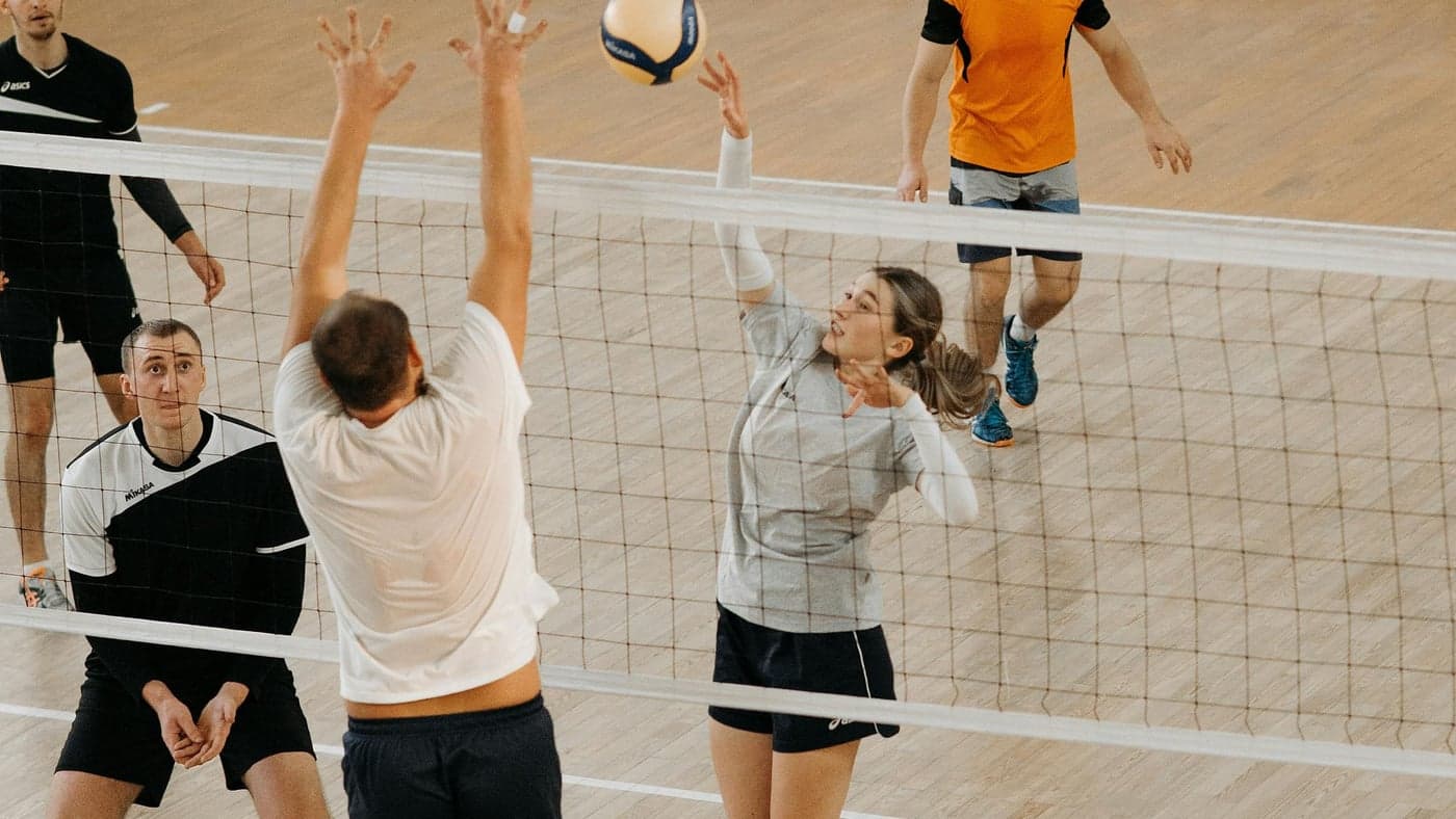 Hitter spiking the ball over the net
