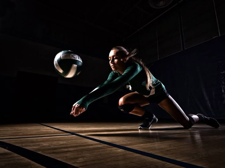 Volleyball player diving to save a ball in dramatic lighting